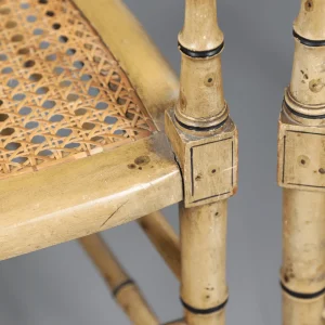A Pair of Cream Painted Simulated Bamboo Elbow Chairs